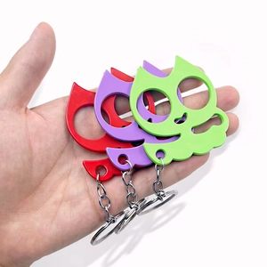 Cat-shaped self-defense keychain set in red, purple, and green with dual finger holes