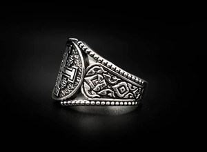 Macro view of vintage stainless steel Jerusalem Cross ring with intricate side carvings