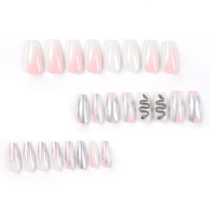 Pink ombre press-on nails with silver flame patterns and 3D snake rhinestone charms