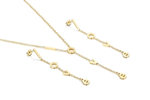 Close-up of golden necklace and earring set with LOVE letters and round pendants