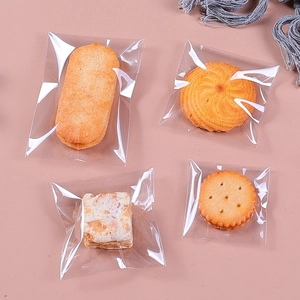 Transparent plastic heat seal bags for cookies and cranberry biscuits with a pink background