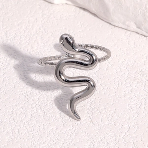 Polished silver stainless steel snake ring on white stone background with diagonal view