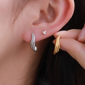 Minimalist textured wing earrings in gold and silver finish with heart cubic zirconia studs