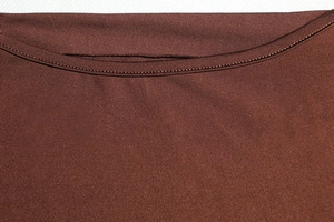 Detailed close-up of crew neck stitching and dark brown ribbed knit fabric texture