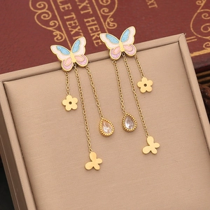 Detail of gold butterfly tassel earrings with pink blue enamel and zircon flowers