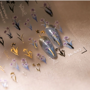Detailed macro view of 5D floral nail stickers with purple iris and gold accents