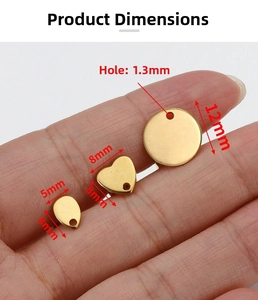 Detailed view of gold geometric earring charms in heart, drop and round shapes with sizes