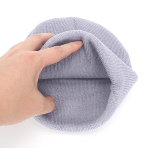 Detail of grey knitted kids hat showing elastic weave texture and thickness
