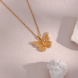 Detailed view of a gold-plated butterfly pendant featuring sparkling white zircon stones