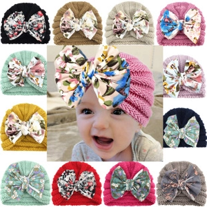 Collage of knit baby beanies in various candy colors featuring a large floral bow detail