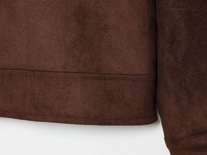 Detail view of the brown faux suede jacket hem featuring high-quality double stitching