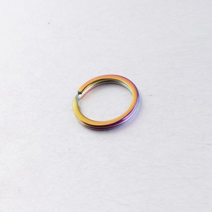 Detail of rainbow colored stainless steel flat key ring with metallic mirror finish