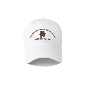 Detailed close-up of brown bear embroidery on a white cotton baseball cap with text