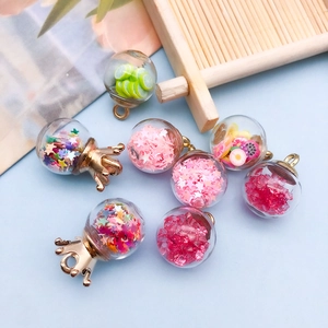 Flat lay of glass globe pendants filled with colorful stars and lemon slices for DIY crafts