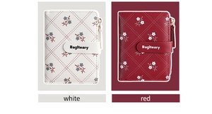 Detail of short PU leather wallets with quilted floral patterns in white and red colors