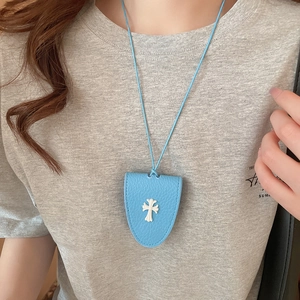 Detail of light blue lychee pattern leather magnetic glasses clip necklace with cross