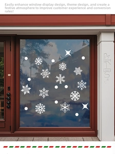 Detailed view of white snowflake window stickers applied on a shop window for Christmas