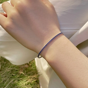 Detail of 2mm S925 sterling silver tennis bracelet with navy blue round cut zircons