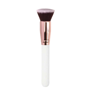 Macro view of a white and rose gold blush brush with soft flat-top synthetic bristles