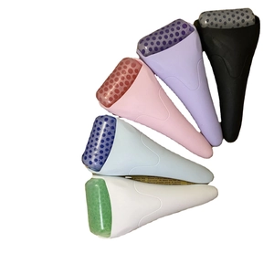 Five facial ice rollers in various colors arranged fan-shaped on white background
