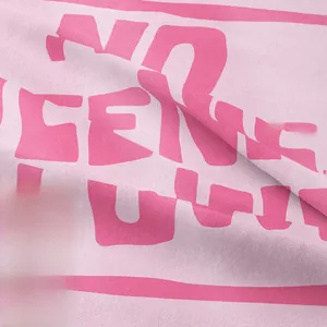 Detailed macro view of pink knitted fabric texture with printed white typography