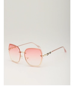 Detail view of pink gradient rimless sunglasses with gold metal frame at a 45-degree angle