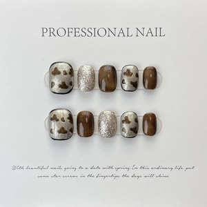 Handmade short square press-on nails with amber, silver glitter and cow print designs
