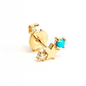 Macro view of gold star stud earring with blue gemstone and sparkling white diamond