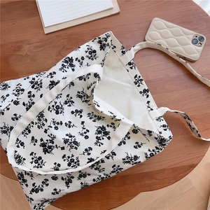 Close-up of floral cotton tote bag showing the interior label and textured fabric details