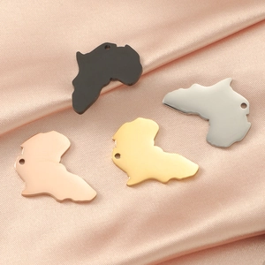 Polished Africa map charms in gold, silver, black, and rose gold on pink silk