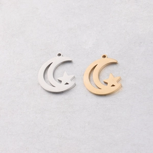 Detailed view of hollow moon and star pendants in silver and gold stainless steel finishes
