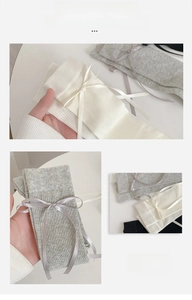 Close-up of rib-knitted socks with delicate satin bow details in multiple colors