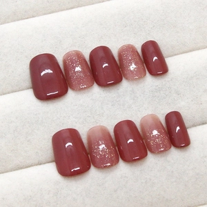 Elegant cherry red gradient press-on nails with golden glitter finish in 10-piece set