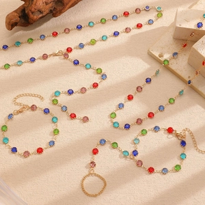 Chic gold-plated Y-necklace and matching rhinestone bracelet set on a natural stone base