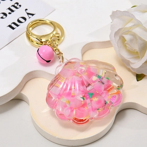 Pink seashell liquid oil keychain with floating beads and a small pink bell charm