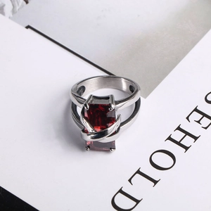 Detailed shot of a rectangular ruby stone set in a silver-toned stainless steel cross ring