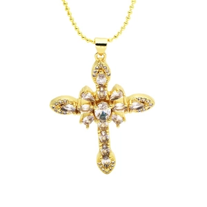 Golden cross pendant necklace with sparkling white zircons on a beaded chain