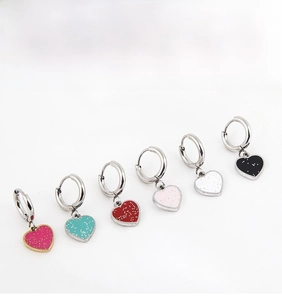 Detail view of colorful heart hoop earrings in six glitter enamel finishes for women