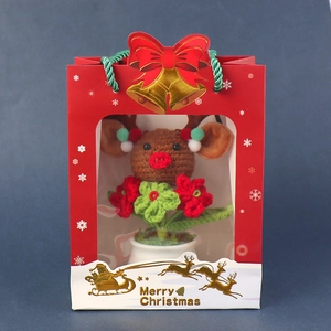 Handcrafted crochet reindeer potted plant in a festive red Merry Christmas gift bag