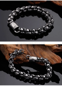 Macro view of gothic punk skull bracelet in vintage silver stainless steel on driftwood