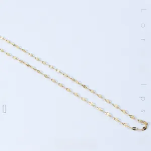 Macro detail of high-polish vacuum gold-plated titanium steel snake chain necklace