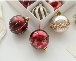 Detailed view of red and beige Christmas ornaments with glitter patterns and bead textures