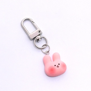 Close-up of pink resin bunny keychain with soft silicone finish and silver metal ring