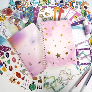 Detailed flat lay of children DIY journal set with starry notebooks and stickers