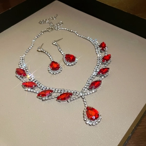 Close-up of sparkling waterdrop red rhinestone necklace and earrings bridal jewelry set