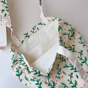 Detail of floral cotton tote bag showing interior pocket and reinforced stitching
