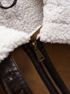Macro detail of faux shearling collar and leather piping on brown vintage vest jacket