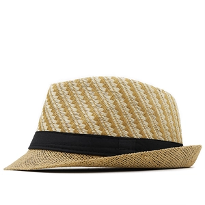 Detail of classic straw fedora featuring two-tone woven texture and wide black ribbon trim