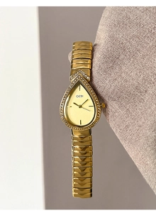 Detailed view of water drop-shaped gold watch with diamonds on wavy chain strap