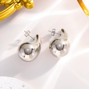 Sleek silver teardrop stud earrings with polished metallic finish on white backdrop